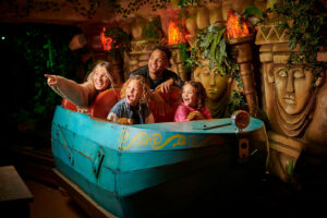 A family of four riding The Toucan Tours ride at Fantasy Island Theme Park, Ingoldmells