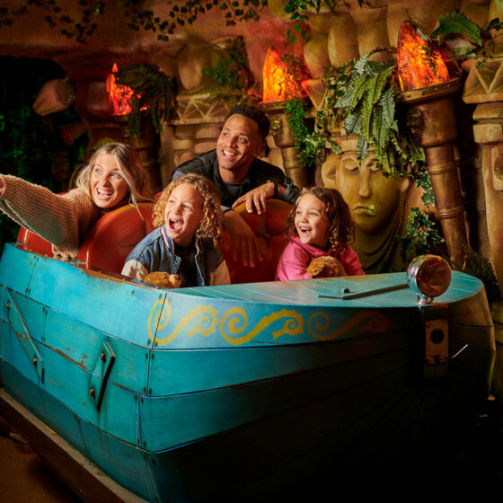 A family of four riding The Toucan Tours ride at Fantasy Island Theme Park, Ingoldmells