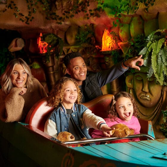 A family of four riding The Toucan Tours ride at Fantasy Island Theme Park, Ingoldmells