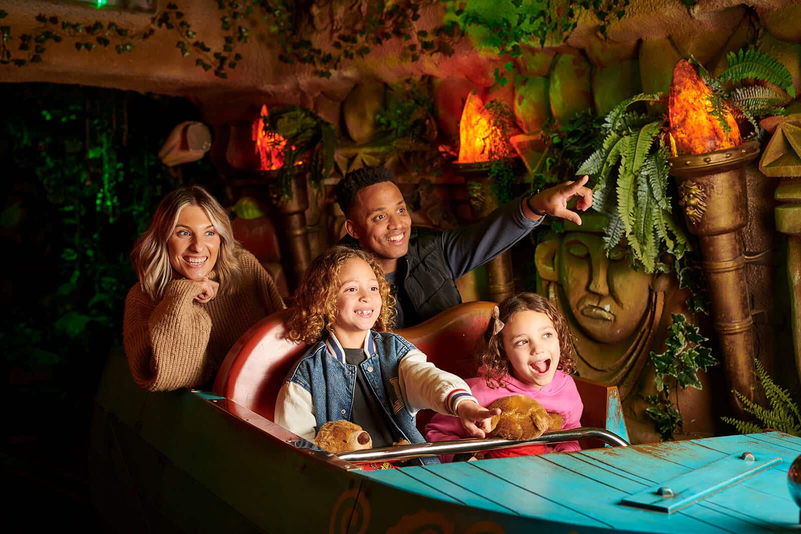 A family of four riding The Toucan Tours ride at Fantasy Island Theme Park, Ingoldmells