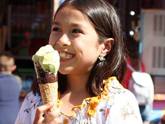 A young girl enjoying an ice cream at Fantasy Island theme park in Ingoldmells